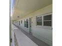 Exterior balcony view of unit with white railing, white walls and a view of the neighborhood at 2257 World Parkway W Blvd # 61, Clearwater, FL 33763