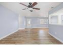 Living room with wood-look flooring, ceiling fan, and ample natural light at 2813 21St W Ave, Bradenton, FL 34205