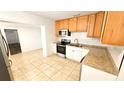 Efficient kitchen includes stainless appliances, light wood cabinets, and durable countertops at 530 74Th N Ave, St Petersburg, FL 33702
