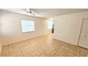 Bright living room features tile flooring, neutral paint, and large window with blinds at 530 74Th N Ave, St Petersburg, FL 33702