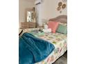 Comfortable bedroom with a wicker bed frame, complemented by coastal-themed decor and natural light at 6320 Cedar St Ne, St Petersburg, FL 33702