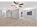 Bright, open living space with ceiling fans, recessed lighting, and neutral-toned flooring at 15609 Timberline Dr, Tampa, FL 33624