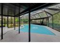 Screened in pool area with pool and patio area for entertaining at 15609 Timberline Dr, Tampa, FL 33624