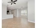Spacious living room featuring neutral tile flooring, abundant natural light, and an open layout at 11314 Grand Park Ave, Riverview, FL 33578