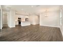 Open-concept living room with hardwood floors seamlessly connects to the kitchen at 9955 Patrician Dr, New Port Richey, FL 34655