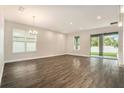 Bright living room with large windows and sliding glass doors to the backyard at 9955 Patrician Dr, New Port Richey, FL 34655