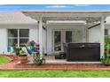 Cozy covered patio with hot tub and string lights, perfect for relaxing at 15364 Mount Sparrow Rd, Weeki Wachee, FL 34614