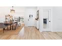 Bright entryway featuring wood floors, a decorative light fixture, and an open dining area at 2556 Arborwood Dr, Valrico, FL 33596