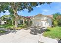 Inviting single-story home with a large front yard and attached two-car garage at 2556 Arborwood Dr, Valrico, FL 33596