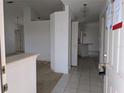 View of entryway with tile flooring, showcasing an open layout leading to the kitchen and other rooms at 1140 Belmar Ave, Port Charlotte, FL 33948