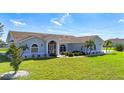 Inviting single-Gathering home boasting a well-maintained lawn, mature landscaping, and a secure screened front entry at 142 Broadmoor Ln, Rotonda West, FL 33947
