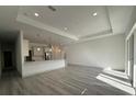 Spacious open-concept living area with recessed lighting and modern gray wood flooring at 1495 Craleigh St, North Port, FL 34288