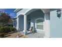 Inviting front porch with decorative columns and textured walls creating a charming entrance at 1884 Coconut Palm Cir, North Port, FL 34288