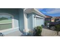 Side view of a two-car garage showcasing the home's architectural details and ample parking space at 1884 Coconut Palm Cir, North Port, FL 34288