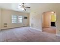 Living room features textured walls, a ceiling fan, and an open doorway to other rooms at 2710 W North A St, Tampa, FL 33609