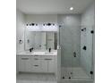 This modern bathroom features a double vanity, a walk-in shower, and elegant fixtures at 16475 Hillsborough Blvd, Port Charlotte, FL 33954