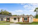 Inviting single-story home with a well-manicured lawn, updated windows, and a cozy, suburban feel at 1740 Lucas Dr, Clearwater, FL 33759