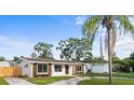 Well-kept single-story home with a spacious yard, updated windows, and complemented by mature trees at 1740 Lucas Dr, Clearwater, FL 33759