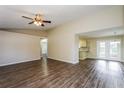 Spacious living room featuring wood flooring and ample natural light, ideal for entertaining and relaxing at 3460 Tomahawk Ave, Spring Hill, FL 34606
