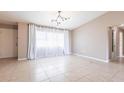 Bright, airy living room with neutral walls, tiled floors, and contemporary lighting at 1049 Presque Isle Dr, Port Charlotte, FL 33952