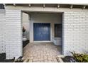 Inviting entryway featuring double doors, brick accents, and a charming brick walkway at 4404 Grainary Ave, Tampa, FL 33624