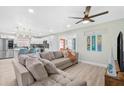 Open living space with modern decor, stylish furnishings, and a view of the kitchen at 4311 123Rd W St, Cortez, FL 34215