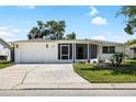 Well-maintained single-story home with manicured lawn and a charming facade during the day at 3410 Allandale Dr, Holiday, FL 34691