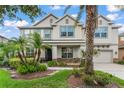 Charming two-story home with landscaped yard, stone accents, and a welcoming front porch at 10720 Breaking Rocks Dr, Tampa, FL 33647