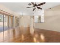 Bright living room with hardwood floors and sliding glass doors to the patio at 23109 Emerson Way, Land O Lakes, FL 34639
