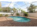 Relaxing screened-in pool area with a brick patio at 23109 Emerson Way, Land O Lakes, FL 34639