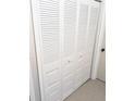 Picture showcasing a louvered-door closet with bi-fold doors and ample storage space at 6640 121St Ave # 1, Largo, FL 33773