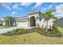 Attractive single-story home with a well-maintained lawn, lush landscaping, and a convenient two-car garage at 9581 Vibrant Lane, Venice, FL 34292