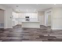 Open-concept living space with a modern kitchen and wood-look flooring throughout at 11126 Jenny Wren Rd, Weeki Wachee, FL 34614