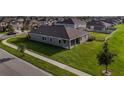 An aerial view of a single-story home showcasing the backyard, and surrounding neighborhood at 11818 Tetrafin Dr, Riverview, FL 33579