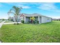 Beautiful single-story home with lush green lawn and landscaped garden at 11818 Tetrafin Dr, Riverview, FL 33579