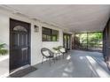 Inviting screened porch with comfortable seating, ideal for relaxing outdoors at 709 1St Ne Ave, Largo, FL 33770