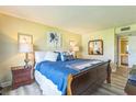 Bedroom with updated flooring, ensuite bath and coastal decor at 3805 E Bay Dr # 204, Holmes Beach, FL 34217
