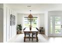 Bright dining room with modern lighting fixture and lots of natural light at 3920 Basswood Dr, Sarasota, FL 34232