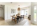 Bright dining room with modern lighting fixture and lots of natural light at 3920 Basswood Dr, Sarasota, FL 34232