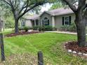 Beautifully landscaped home with lush green lawn and a sidewalk leading to the front entrance at 10533 Hazel St, Largo, FL 33778