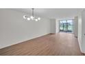 A spacious living room with new wood floors and large glass windows with golf course views at 1967 Cormorant Ct # 516, Clearwater, FL 33762