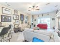 Spacious living area with neutral walls, carpeted floors, bar seating, and lots of art at 20074 Heritage Point Dr, Tampa, FL 33647