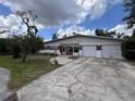 Charming single-story home featuring a two-car garage and a brick facade at 5627 Oakland Dr, Tampa, FL 33617