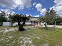 Charming single-story home showcasing the front yard, featuring two palm trees and a lovely lawn at 5627 Oakland Dr, Tampa, FL 33617