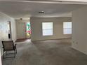 Spacious living room with neutral carpet, large windows, and ample natural light at 4650 Orlando Cir, Bradenton, FL 34207