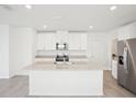 Modern kitchen features granite countertops, stainless steel appliances, and bright white cabinets at 3544 Moscato Dr, Brooksville, FL 34602