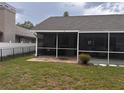 View of screened-in lanai with stone paver flooring and fenced yard at 1403 Ventana Dr, Sun City Center, FL 33573
