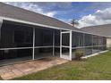 View of screened-in lanai with stone paver flooring at 1403 Ventana Dr, Sun City Center, FL 33573