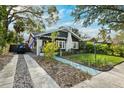 Charming single-Gathering home with a driveway and a manicured front lawn with mature trees at 132 17Th N Ave, St Petersburg, FL 33704
