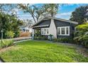 Well-kept home showcasing a green lawn, a charming walkway, and a white brick chimney at 132 17Th N Ave, St Petersburg, FL 33704